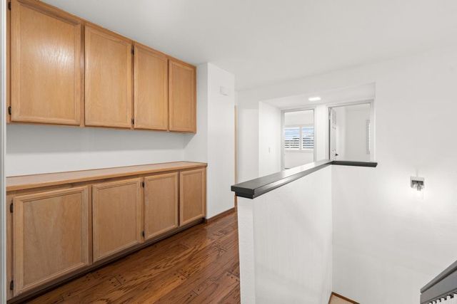a view of a yard with flower plants and wooden fence