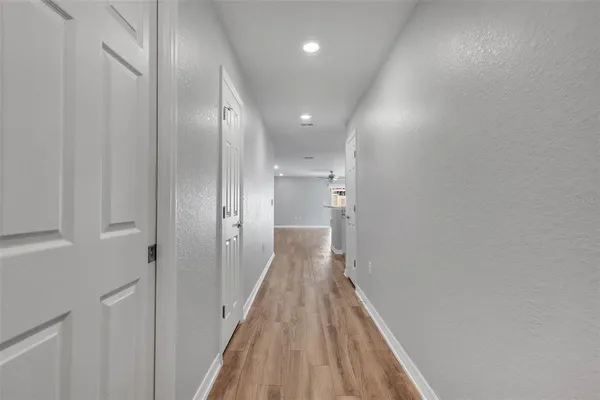 a view of a hallway with wooden floor