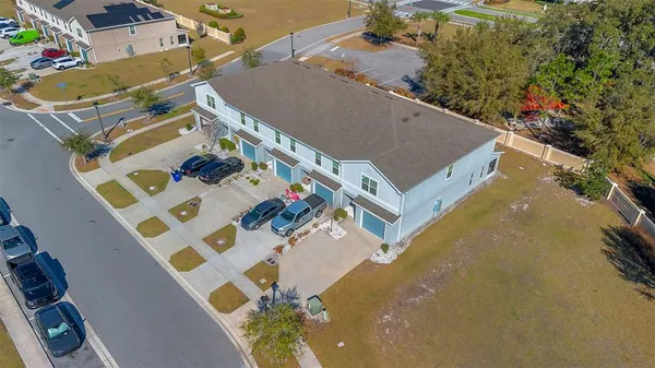 an aerial view of a house with a yard
