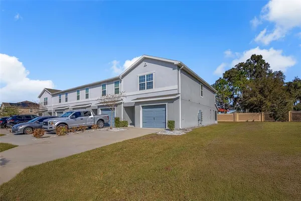 a view of a house with backyard and sitting area