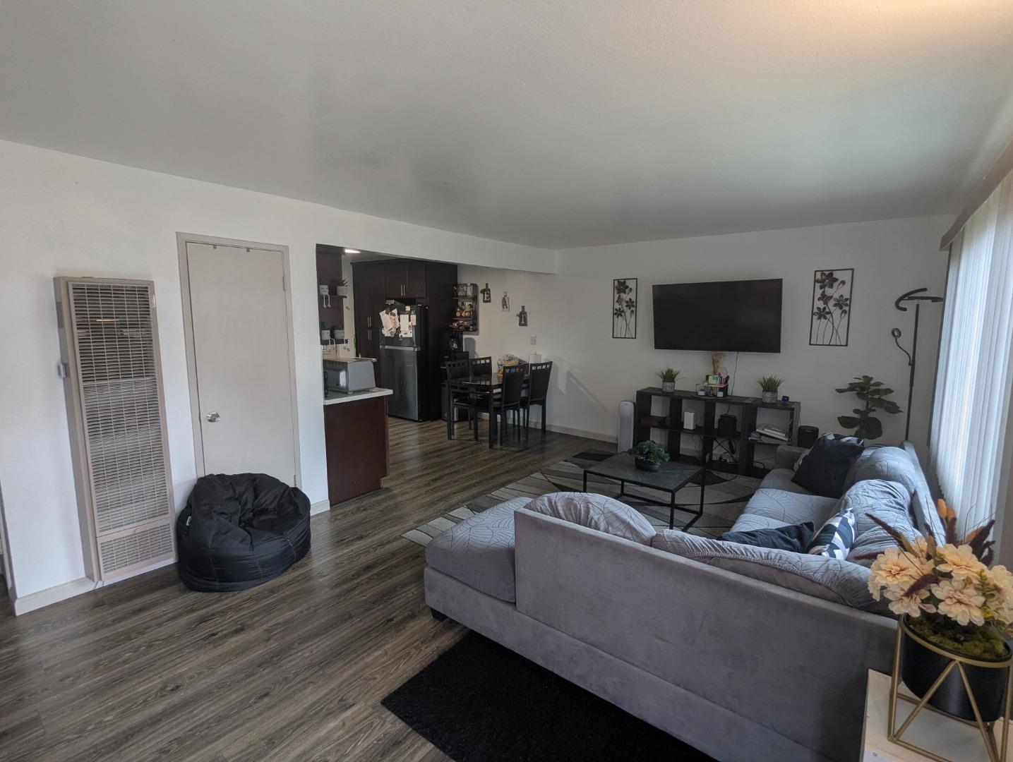250 Schafer Road Hayward, CA 94544 - Photo 12 of 21 a living room with furniture a wooden floor and a flat screen tv