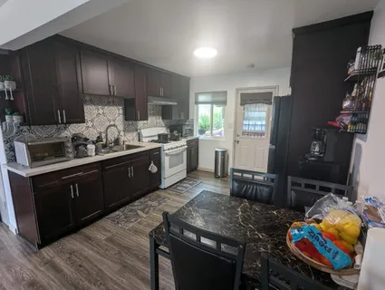 a kitchen with stainless steel appliances granite countertop a sink stove and cabinets