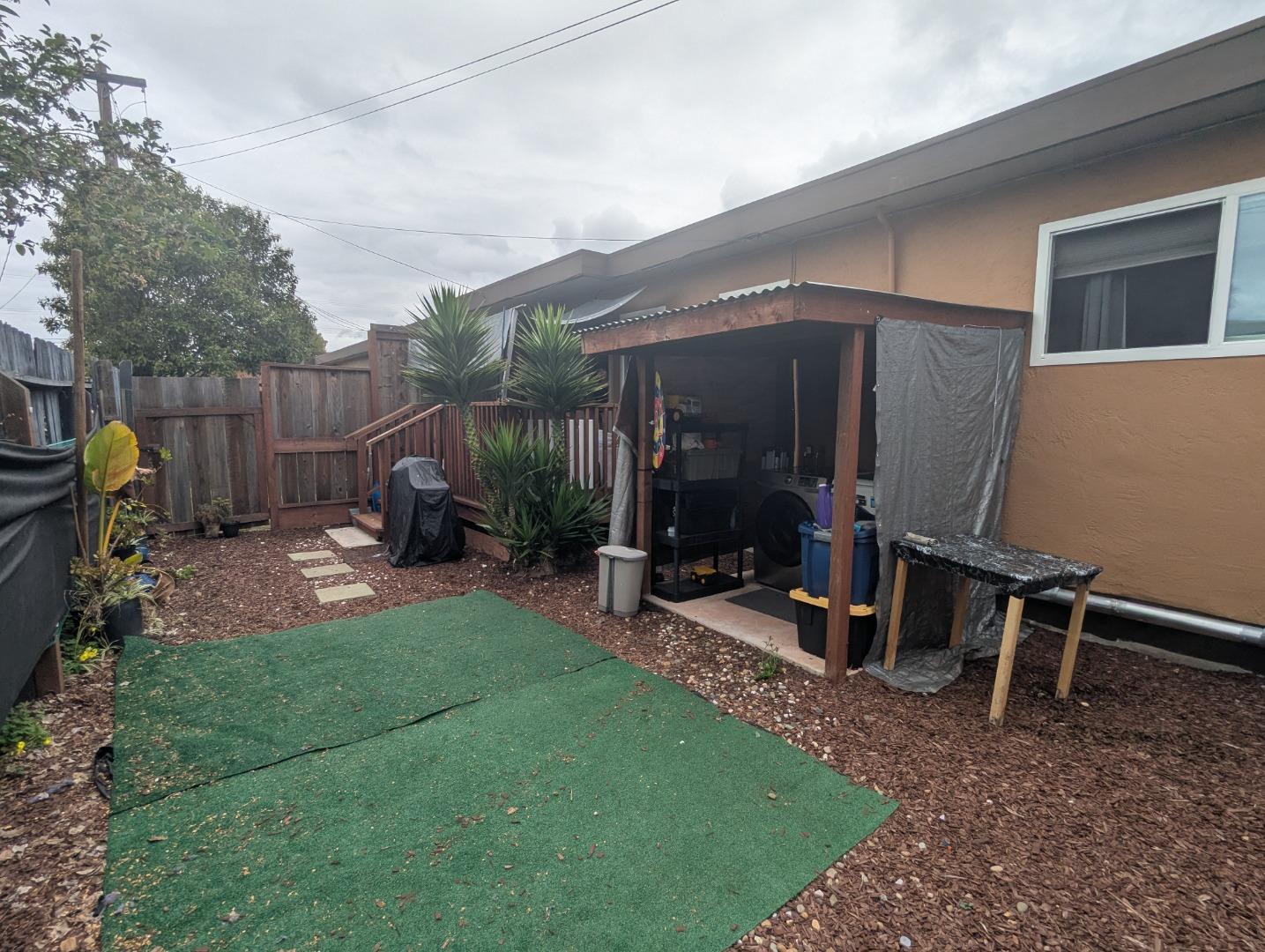 250 Schafer Road Hayward, CA 94544 - Photo 14 of 21 a view of a backyard with table and chairs and wooden fence
