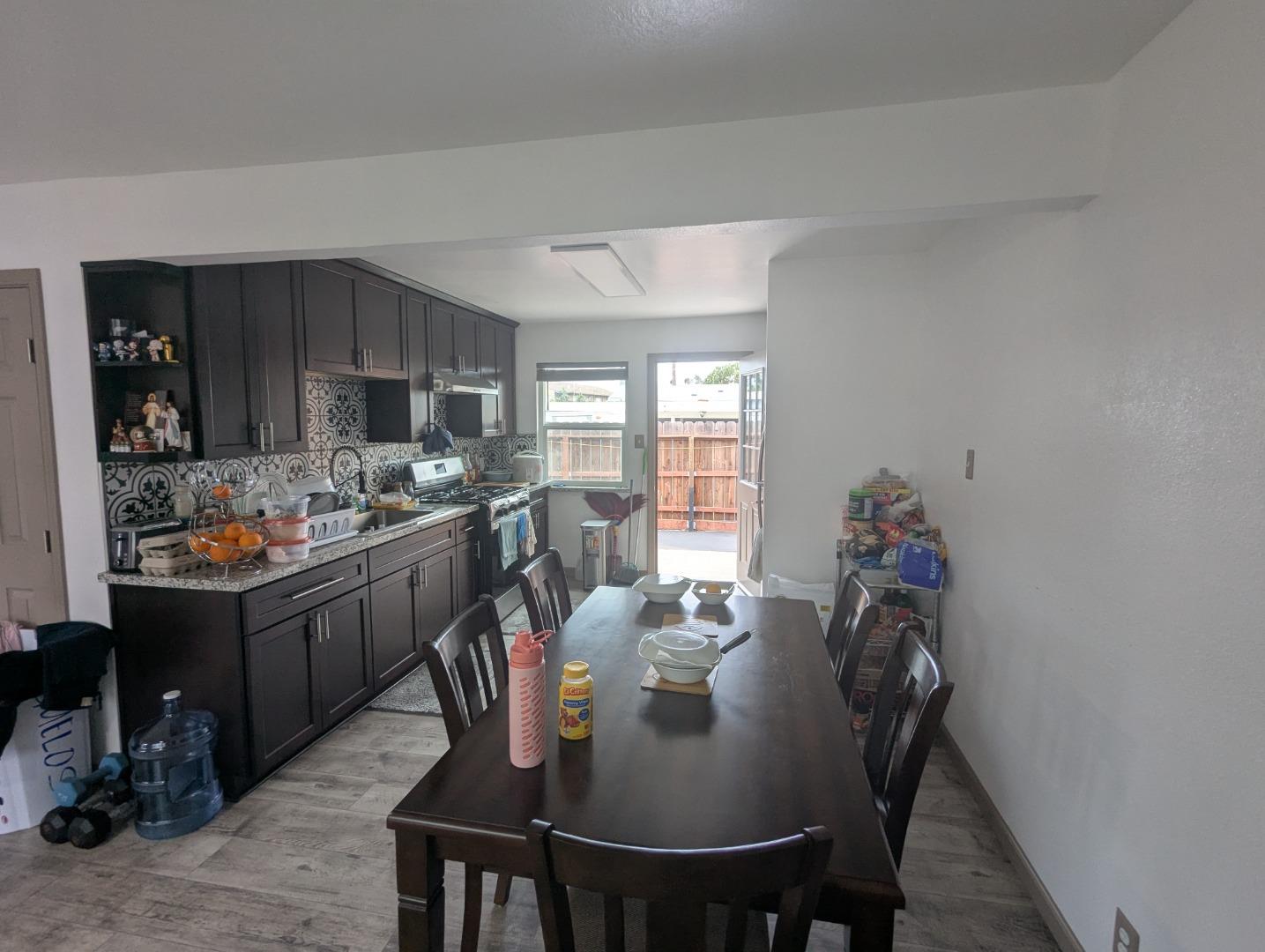 250 Schafer Road Hayward, CA 94544 - Photo 4 of 21 a kitchen with a dining table chairs and refrigerator
