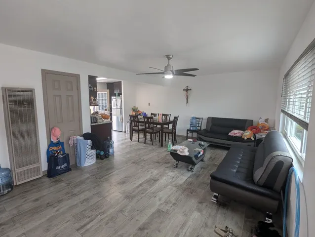 a living room with furniture and wooden floor