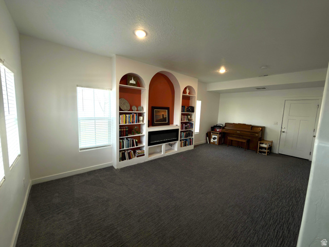 327 West Main Street, Unit 14 Santaquin, UT 84655 - Photo 3 of 20 Sitting room featuring built in shelves and dark colored carpet