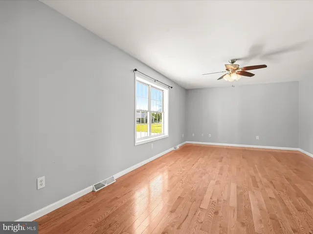 a kitchen with stainless steel appliances a refrigerator a sink dishwasher with a dining table and chairs with wooden floor