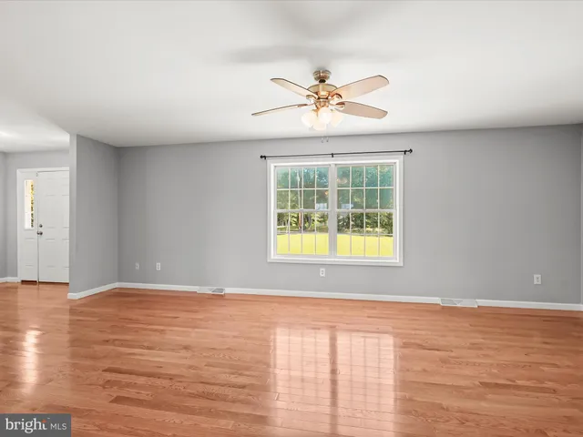 a view of kitchen with stainless steel appliances granite countertop cabinets and window