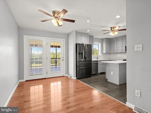 a kitchen with stainless steel appliances a refrigerator sink and cabinets