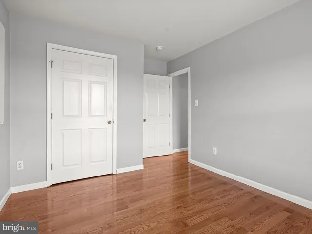 a view of a house with yard and trees in the background