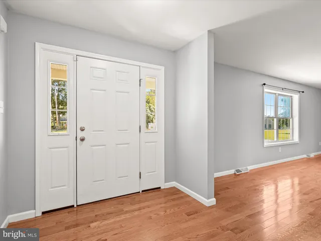 a kitchen with stainless steel appliances granite countertop a refrigerator a stove a sink and a microwave