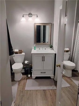 a bathroom with a toilet sink and mirror