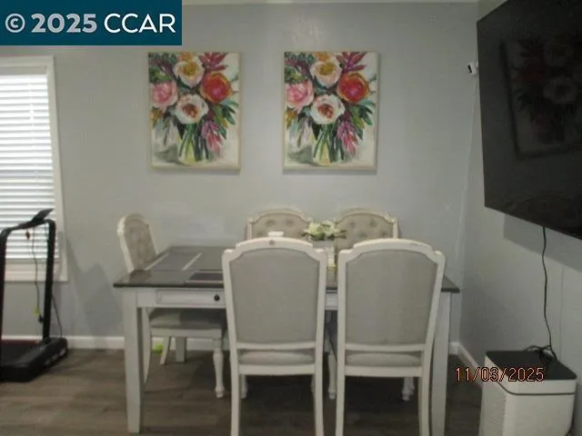 a dining room with furniture and wooden floor