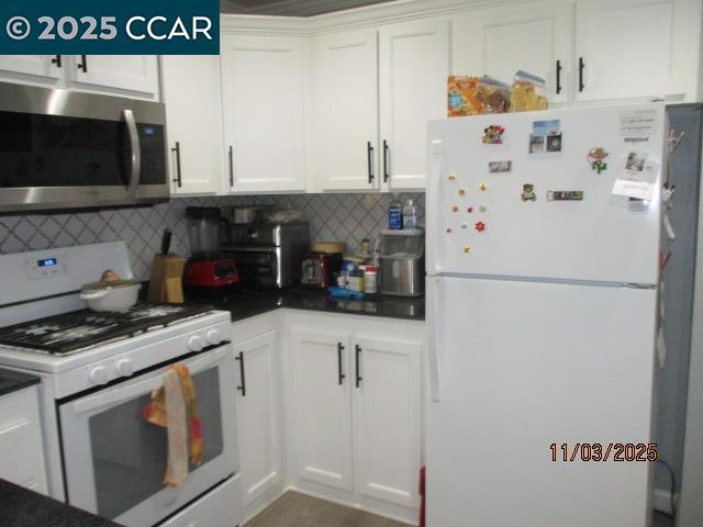 5751 Bridgehead Road Oakley, CA 94561 - Photo 7 of 14 a kitchen with stainless steel appliances a refrigerator a stove and white cabinets