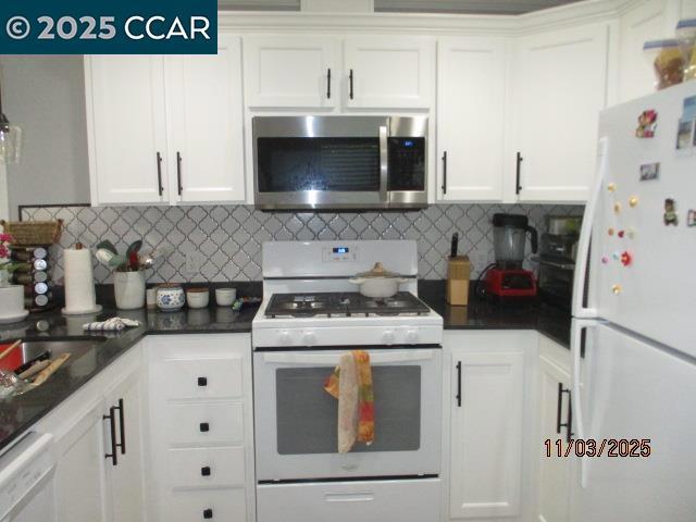 5751 Bridgehead Road Oakley, CA 94561 - Photo 8 of 14 a kitchen with a stove and a microwave