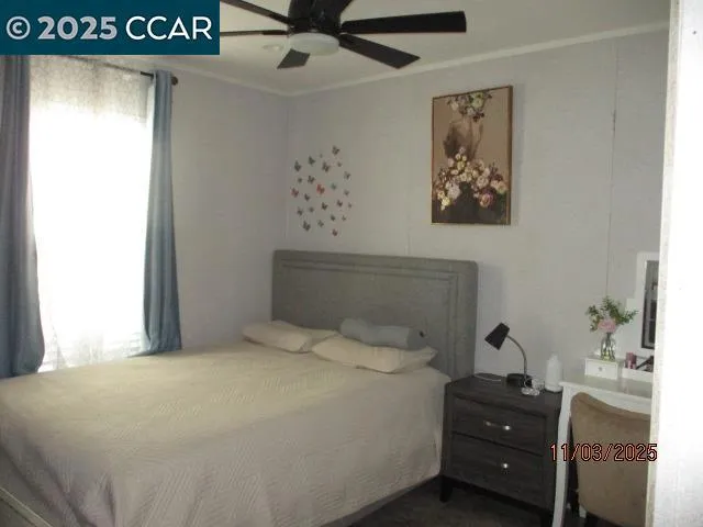 a bedroom with a bed and a window