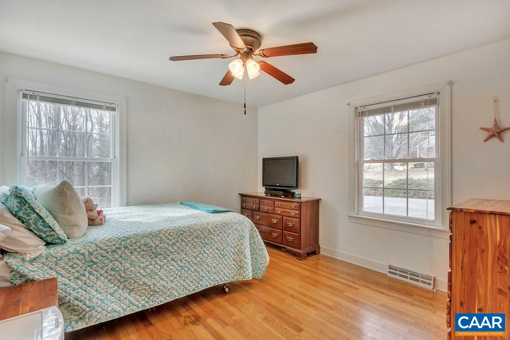 2406 Wakefield Road Charlottesville, VA 22901 - Photo 20 of 31 a bedroom with a bed and wooden floor