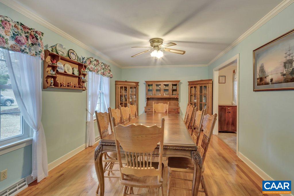 2406 Wakefield Road Charlottesville, VA 22901 - Photo 6 of 31 a view of a dining room with furniture wooden floor and a chandelier