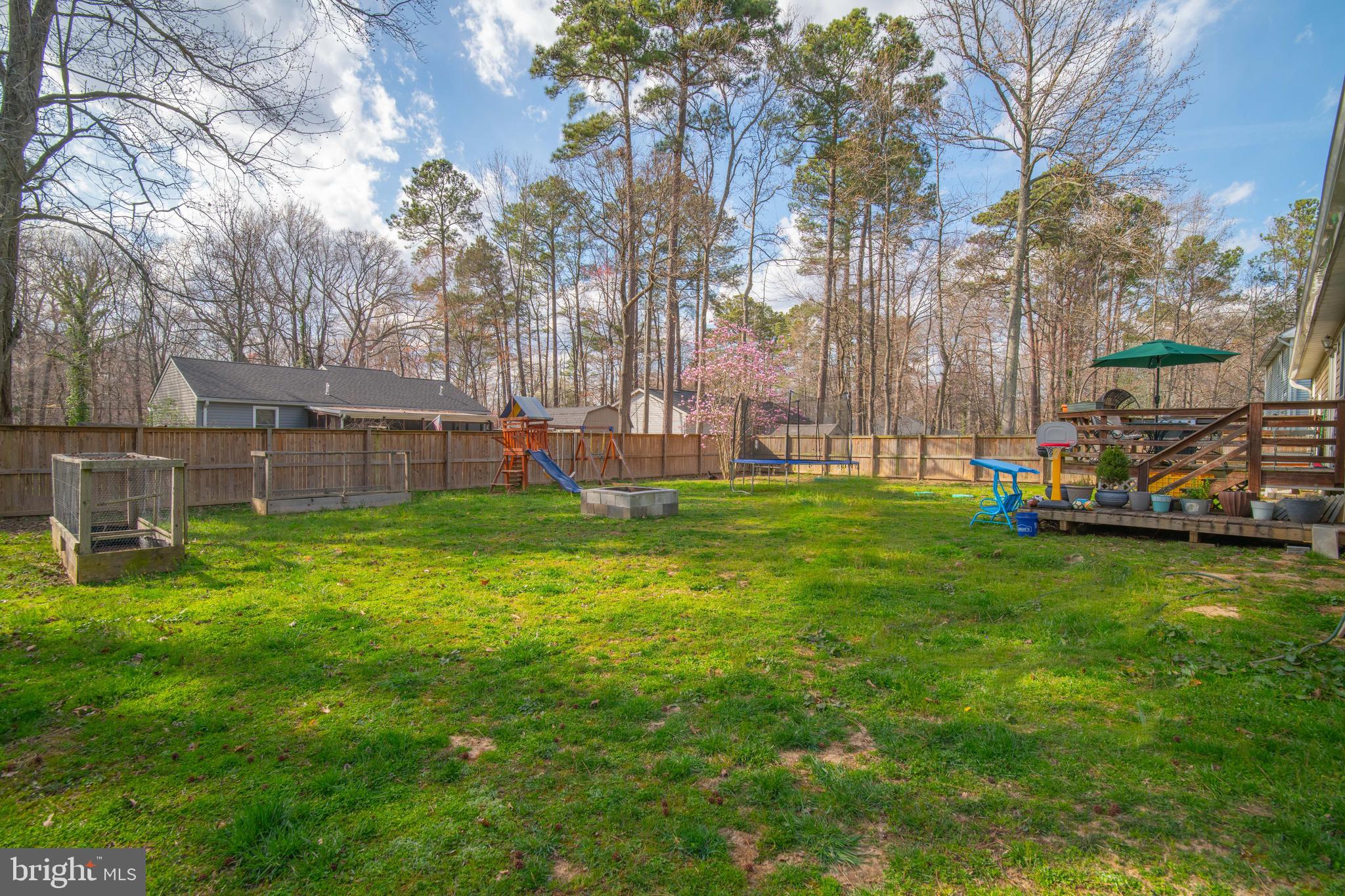 11543 San Rafael Road Lusby, MD 20657 - Photo 19 of 20 a view of backyard with table and chairs and a large tree