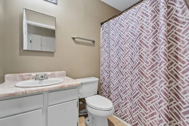 a bathroom with a sink toilet and a mirror