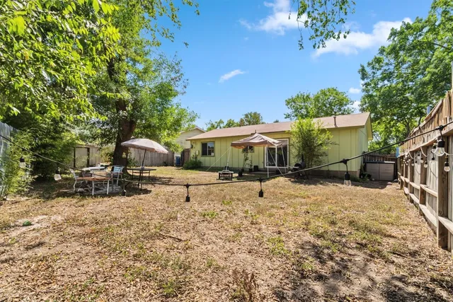 a view of a house with a yard and sitting area