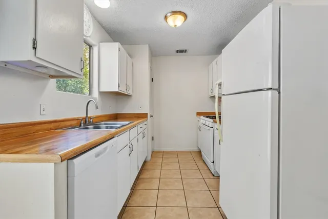 a kitchen with a sink and a refrigerator