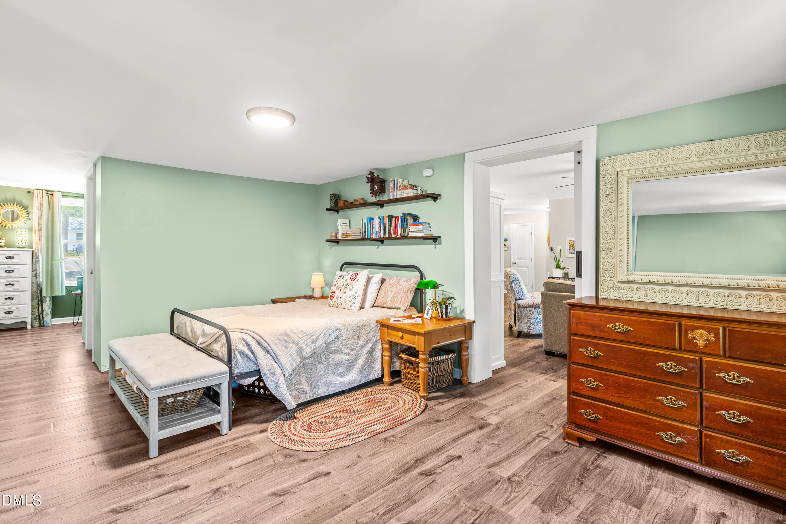 3724 Randell Road Garner, NC 27529 - Photo 14 of 32 a bedroom with a bed and wooden floor