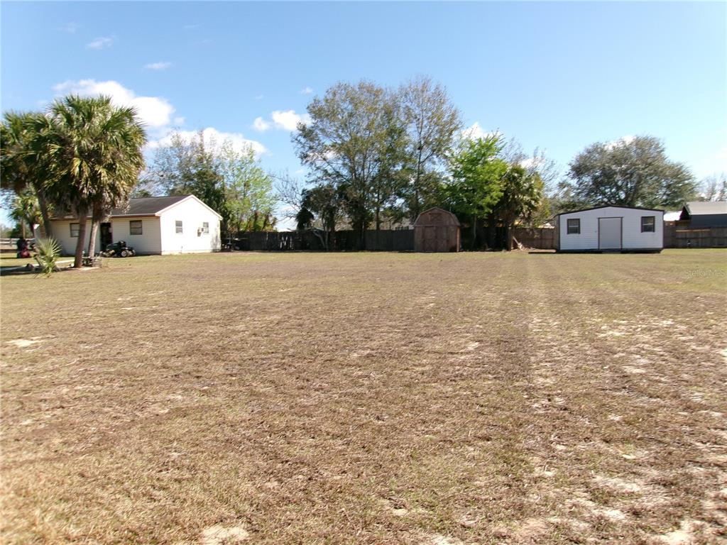 12525 Southeast 83rd Terrace Belleview, FL 34420 - Photo 12 of 47 a house with a yard and a large tree