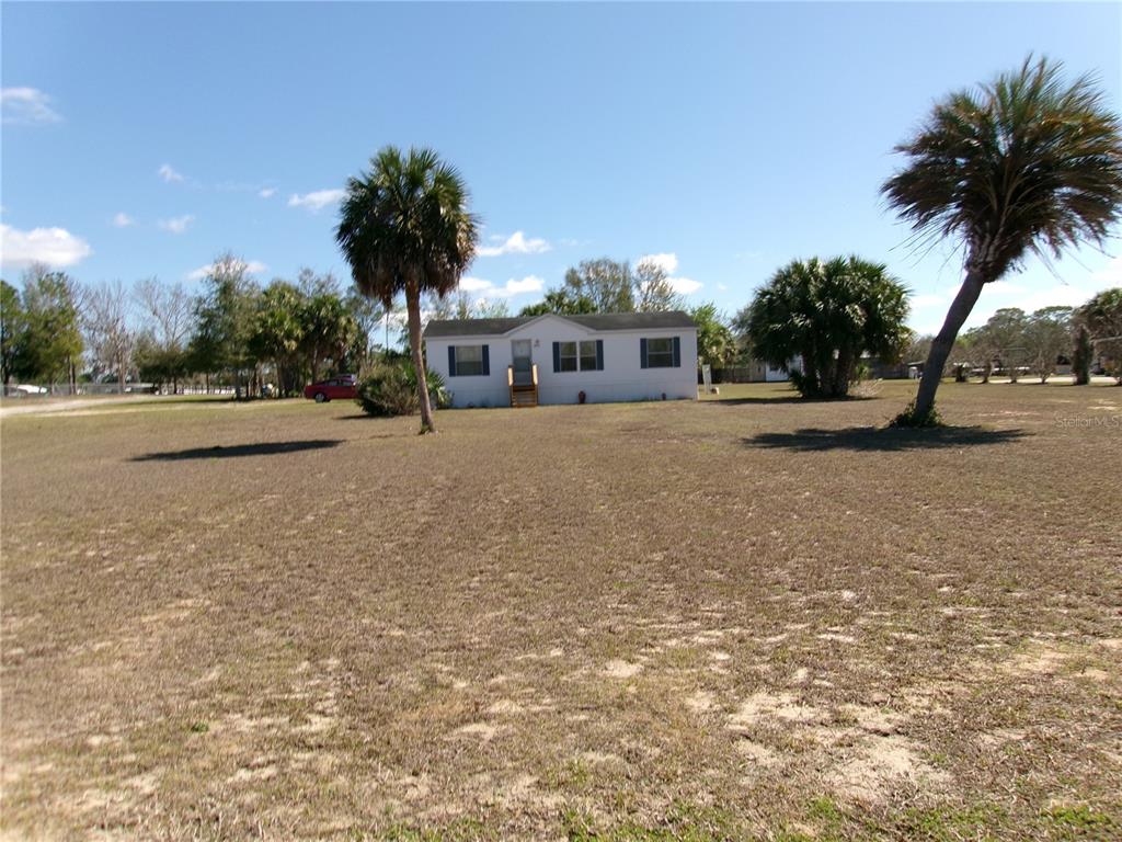 12525 Southeast 83rd Terrace Belleview, FL 34420 - Photo 2 of 47 a front view of a house with a yard and a garage