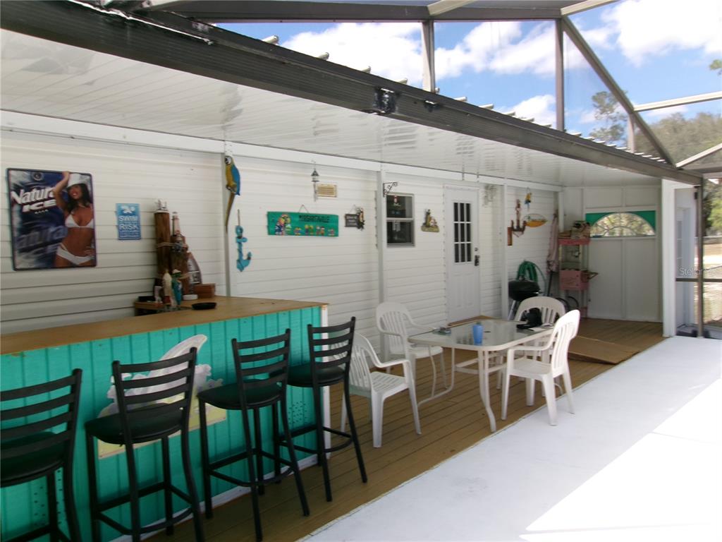 12525 Southeast 83rd Terrace Belleview, FL 34420 - Photo 24 of 47 a view of a patio with table and chairs and potted plants