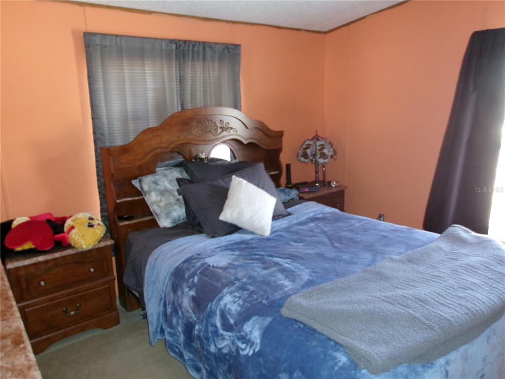 12525 Southeast 83rd Terrace Belleview, FL 34420 - Photo 34 of 47 a bedroom with a bed and a window