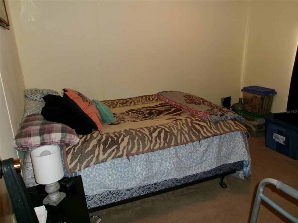 12525 Southeast 83rd Terrace Belleview, FL 34420 - Photo 42 of 47 a bedroom with a bed and a chair