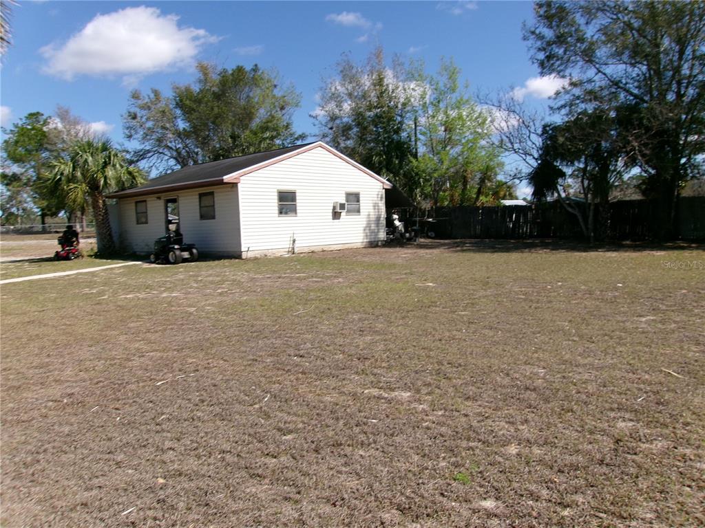 12525 Southeast 83rd Terrace Belleview, FL 34420 - Photo 7 of 47 a view of a house with a yard