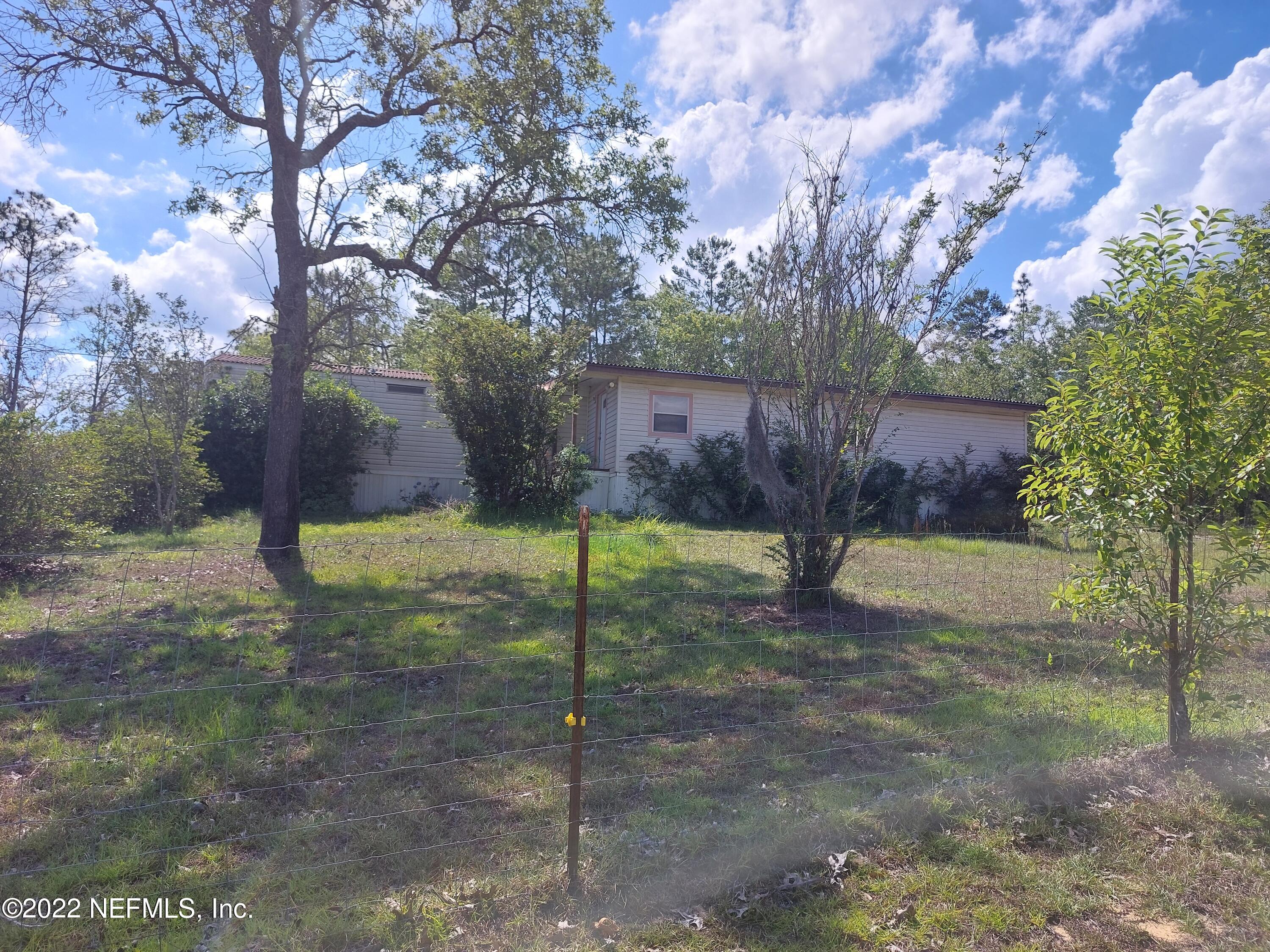 7272 Davidson Street Keystone Heights, FL 32656 - Photo 1 of 16 a view of a backyard with a tree