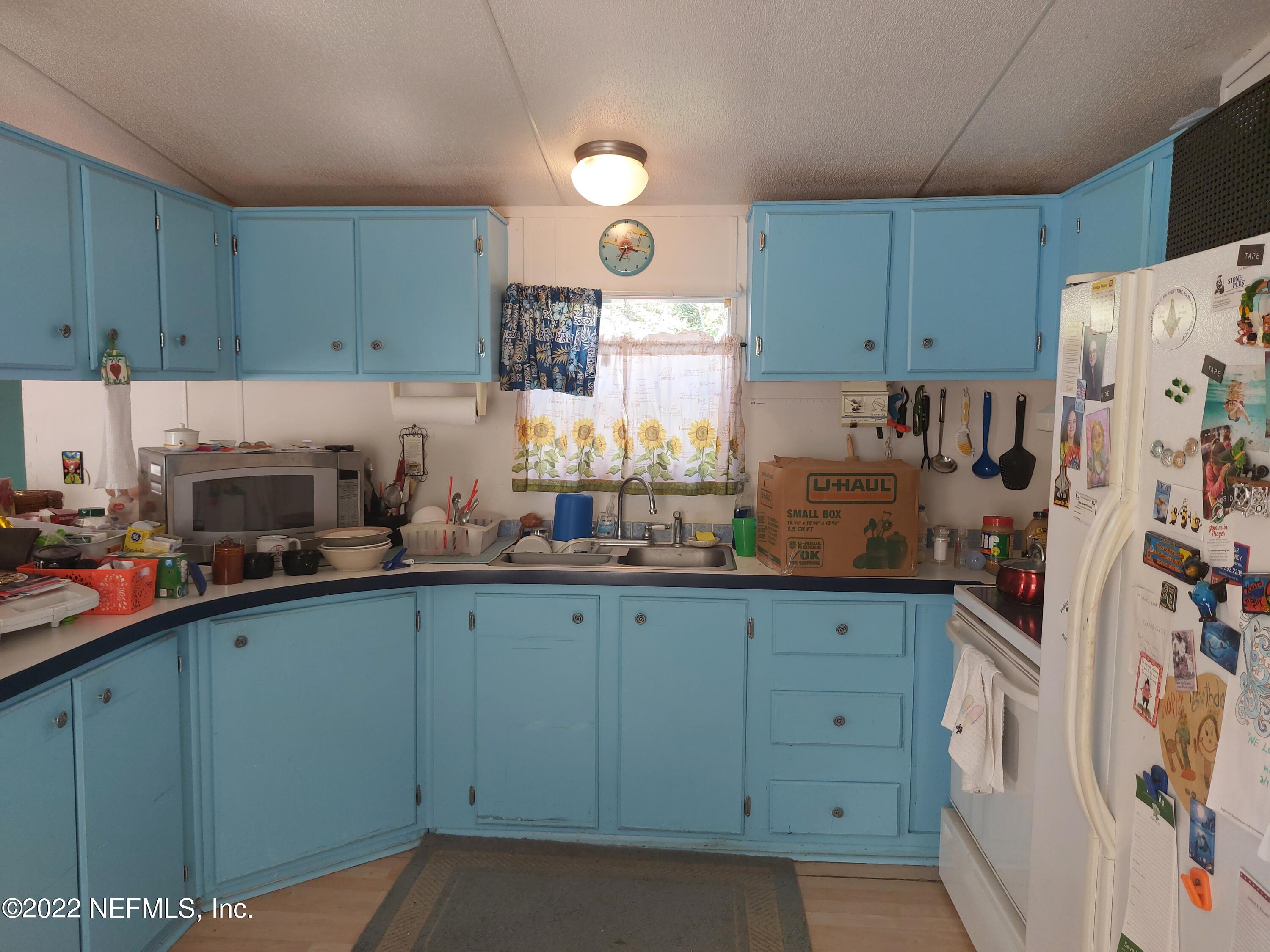7272 Davidson Street Keystone Heights, FL 32656 - Photo 3 of 16 a kitchen with stainless steel appliances granite countertop a refrigerator sink and cabinets