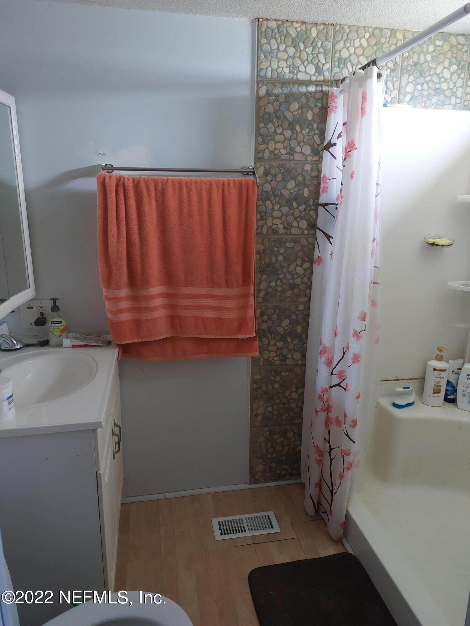 7272 Davidson Street Keystone Heights, FL 32656 - Photo 6 of 16 a bathroom with a sink and a mirror