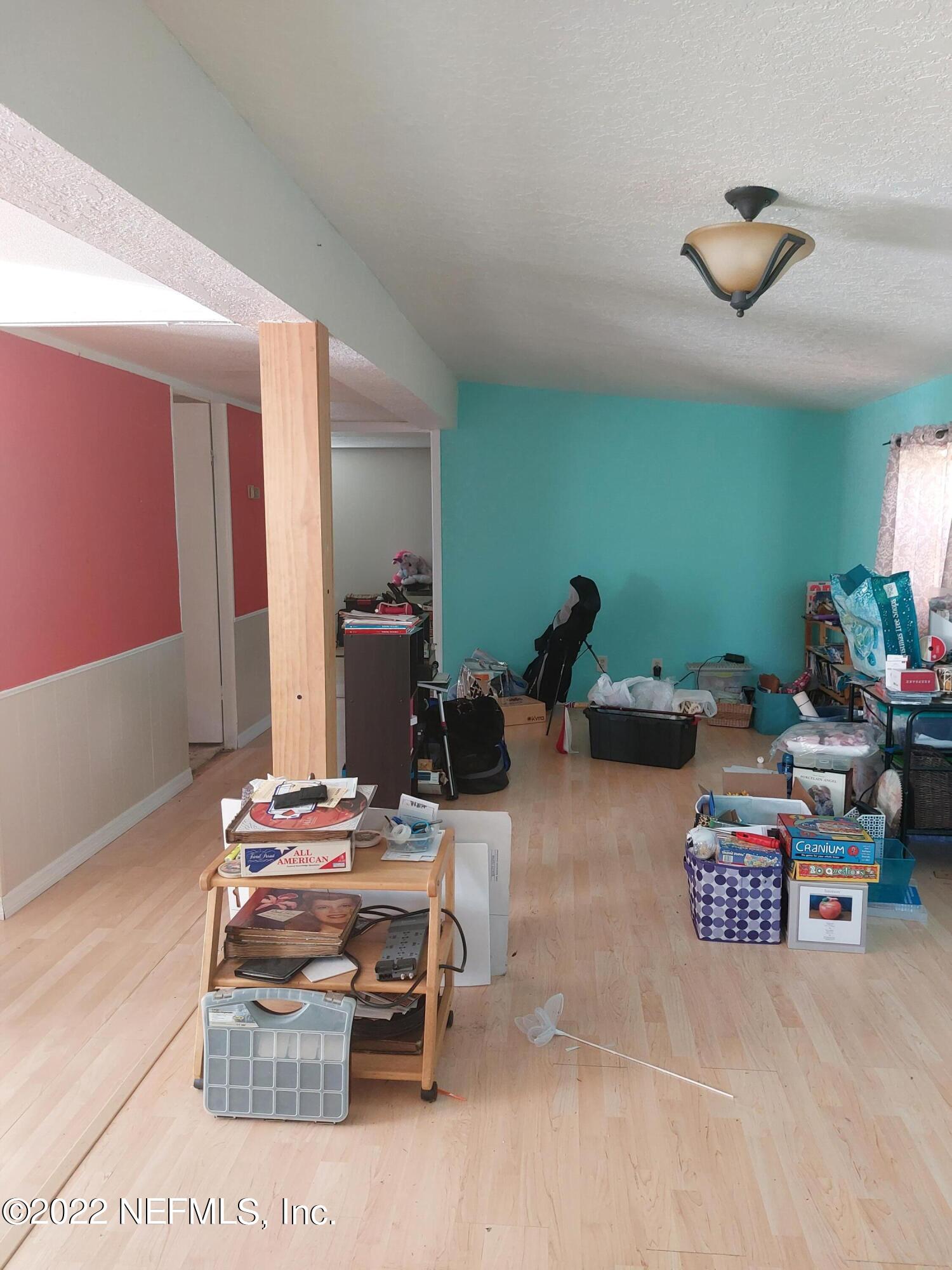7272 Davidson Street Keystone Heights, FL 32656 - Photo 8 of 16 a living room with furniture and a wooden floor