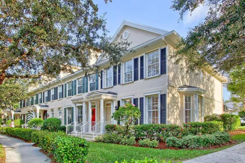 a front view of a residential houses with yard and green space