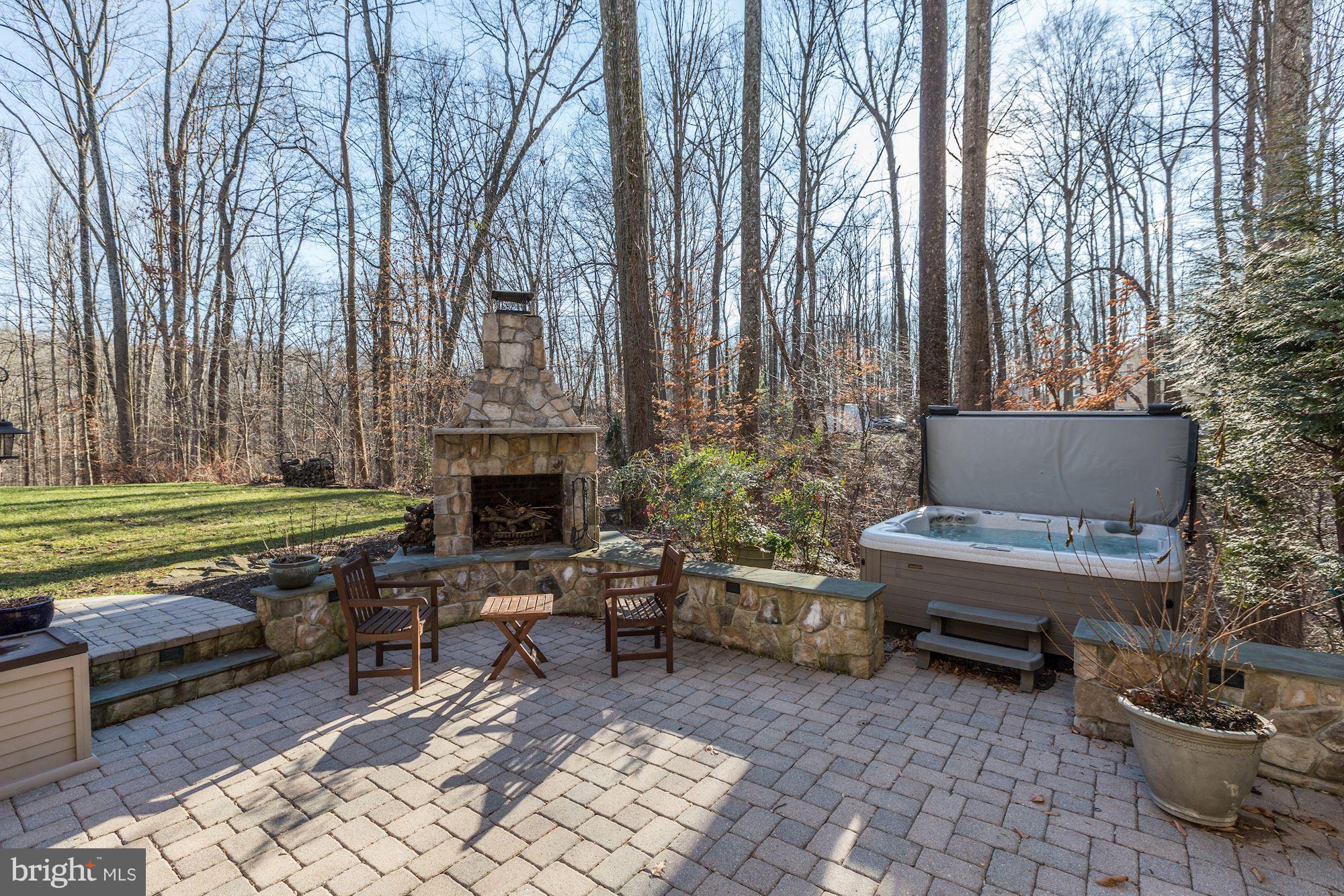 1705 Sinclair Road Gambrills, MD 21054 - Photo 65 of 82 Pavered stone terrace, stone fireplace and hot tub