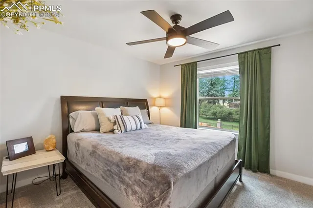 a bedroom with a large bed and a large window