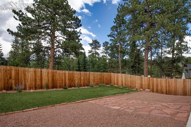 a wooden fence with some trees in the background