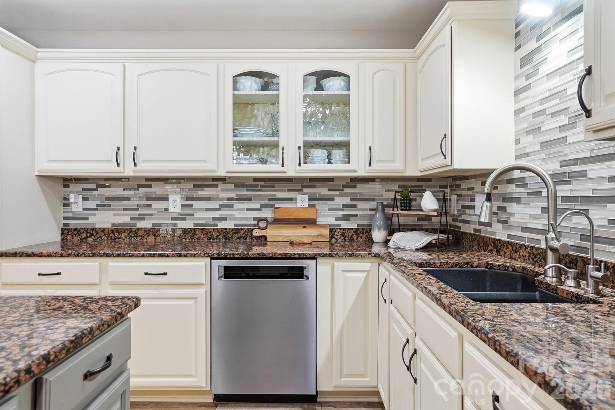 3324 Muddy Creek Road Midland, NC 28107 - Photo 16 of 46 a kitchen with stainless steel appliances granite countertop a sink stove and cabinets