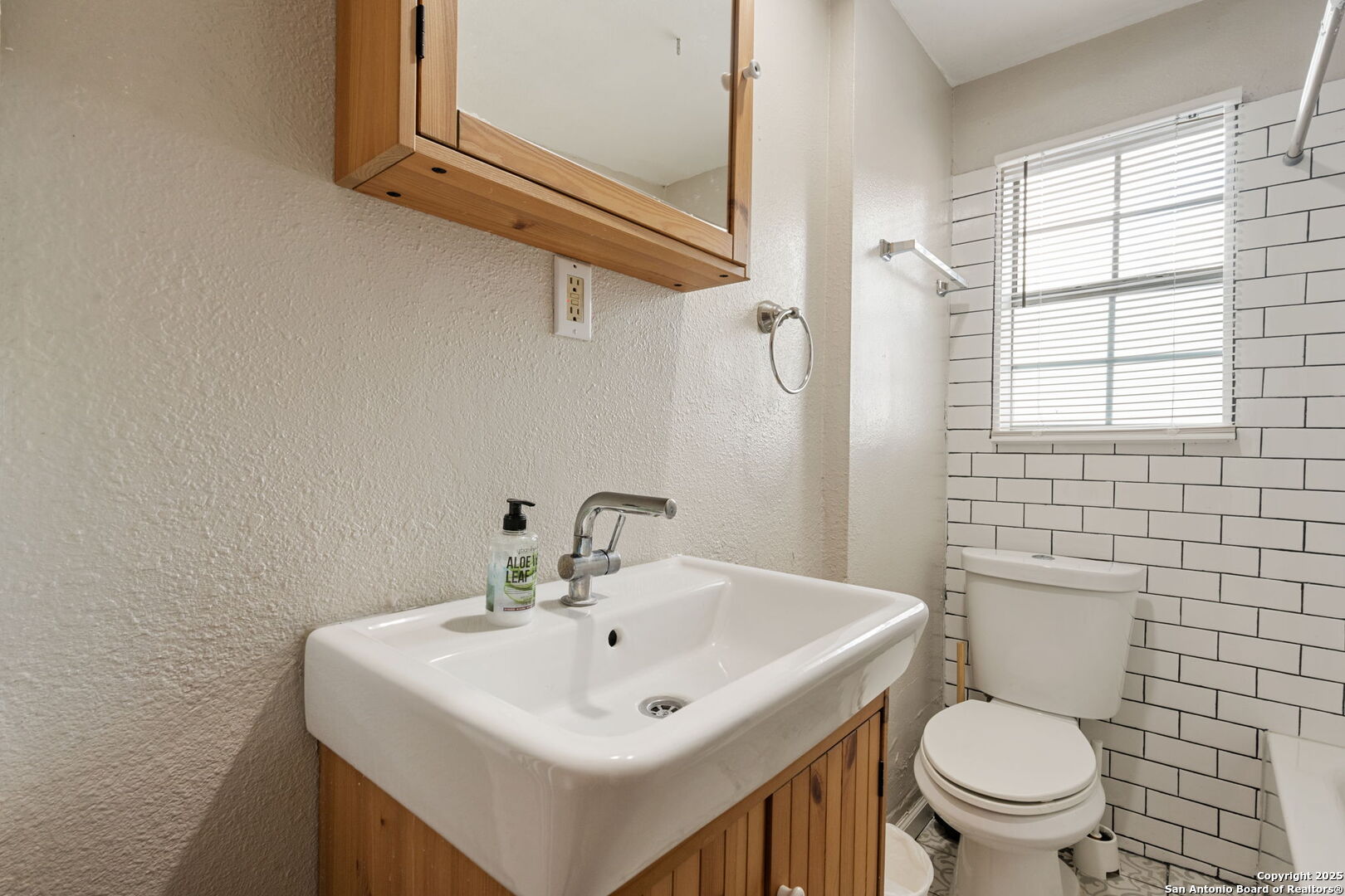 215 Blanco Road San Antonio, TX 78212 - Photo 16 of 48 a white toilet sitting next to a bathroom sink