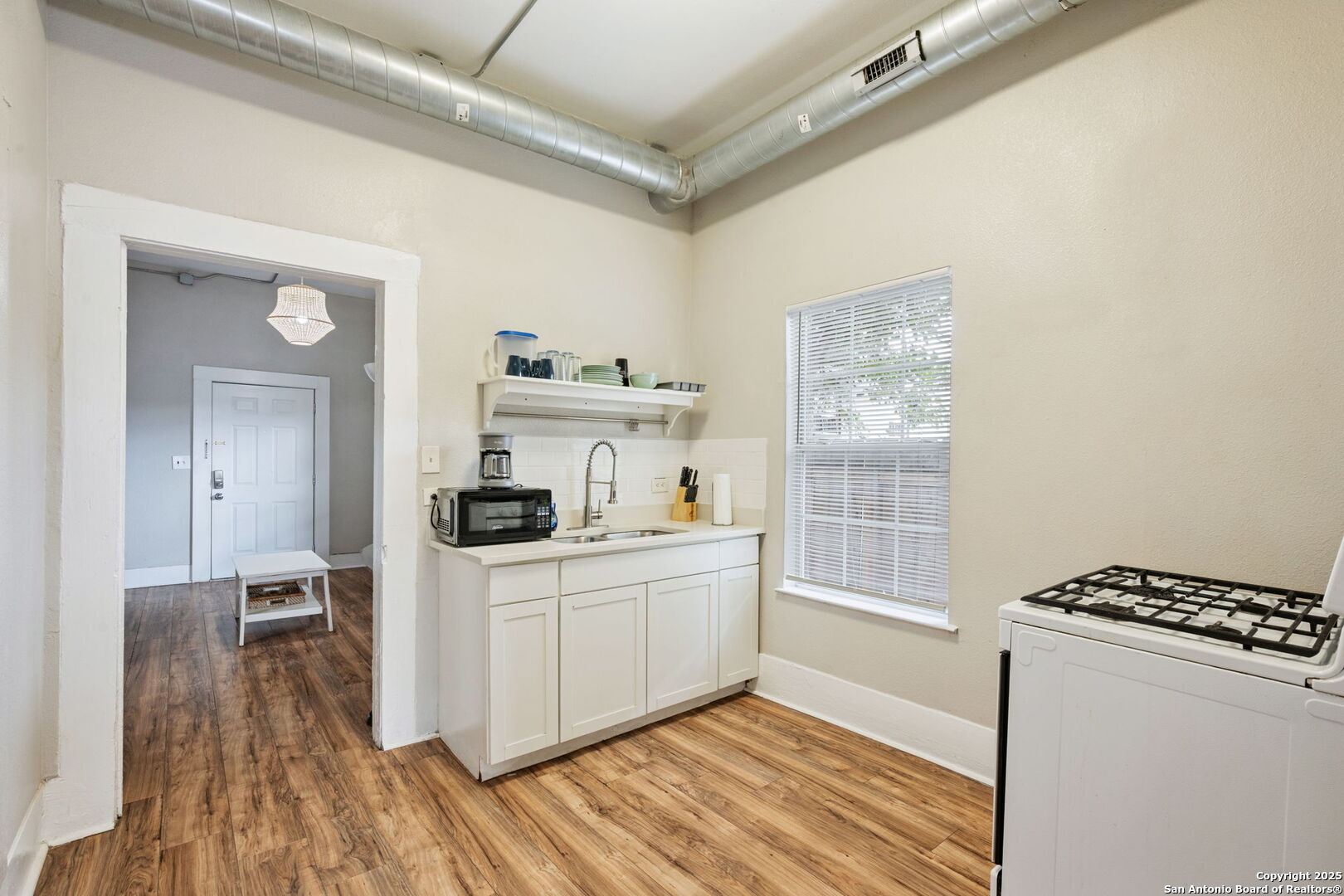 215 Blanco Road San Antonio, TX 78212 - Photo 21 of 48 a kitchen with sink cabinets and wooden floor