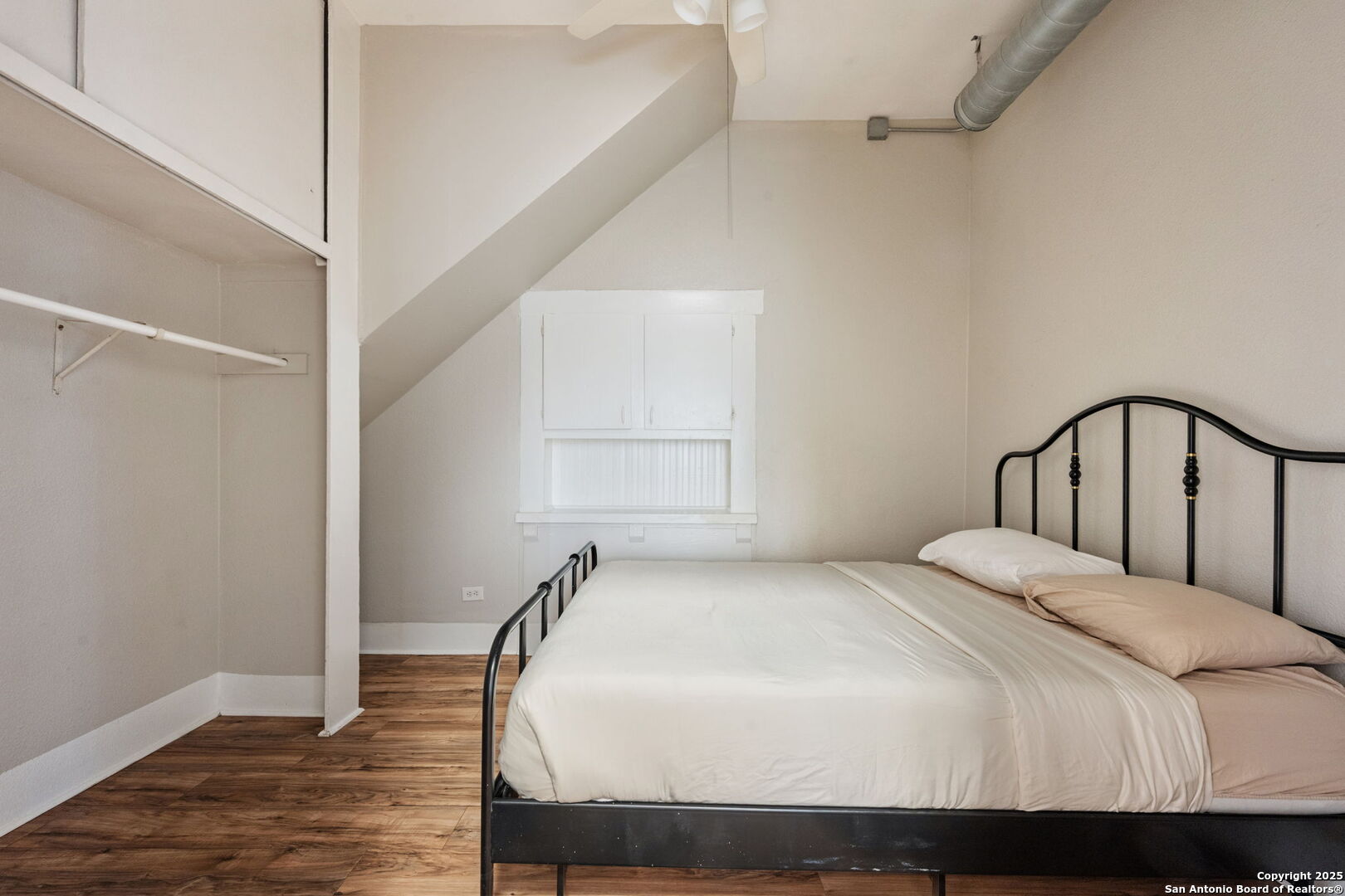 215 Blanco Road San Antonio, TX 78212 - Photo 26 of 48 a bedroom with a bed and wooden floor