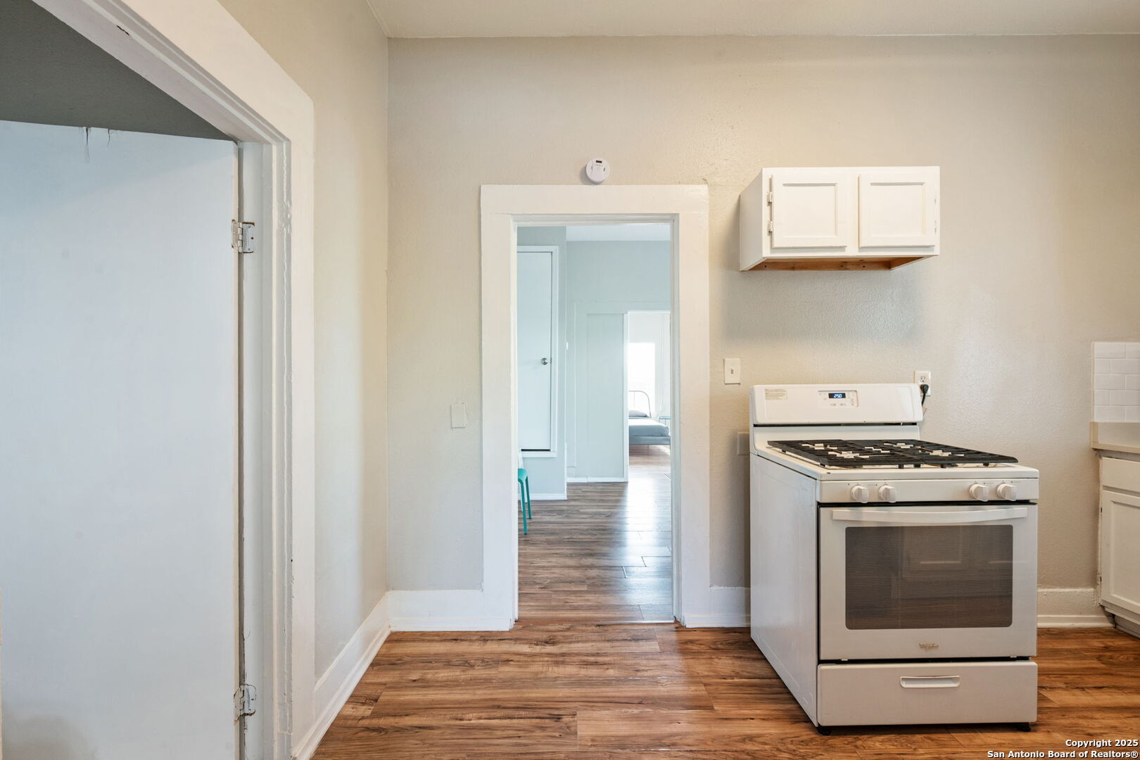 215 Blanco Road San Antonio, TX 78212 - Photo 32 of 48 a kitchen with a stove and a wooden floor