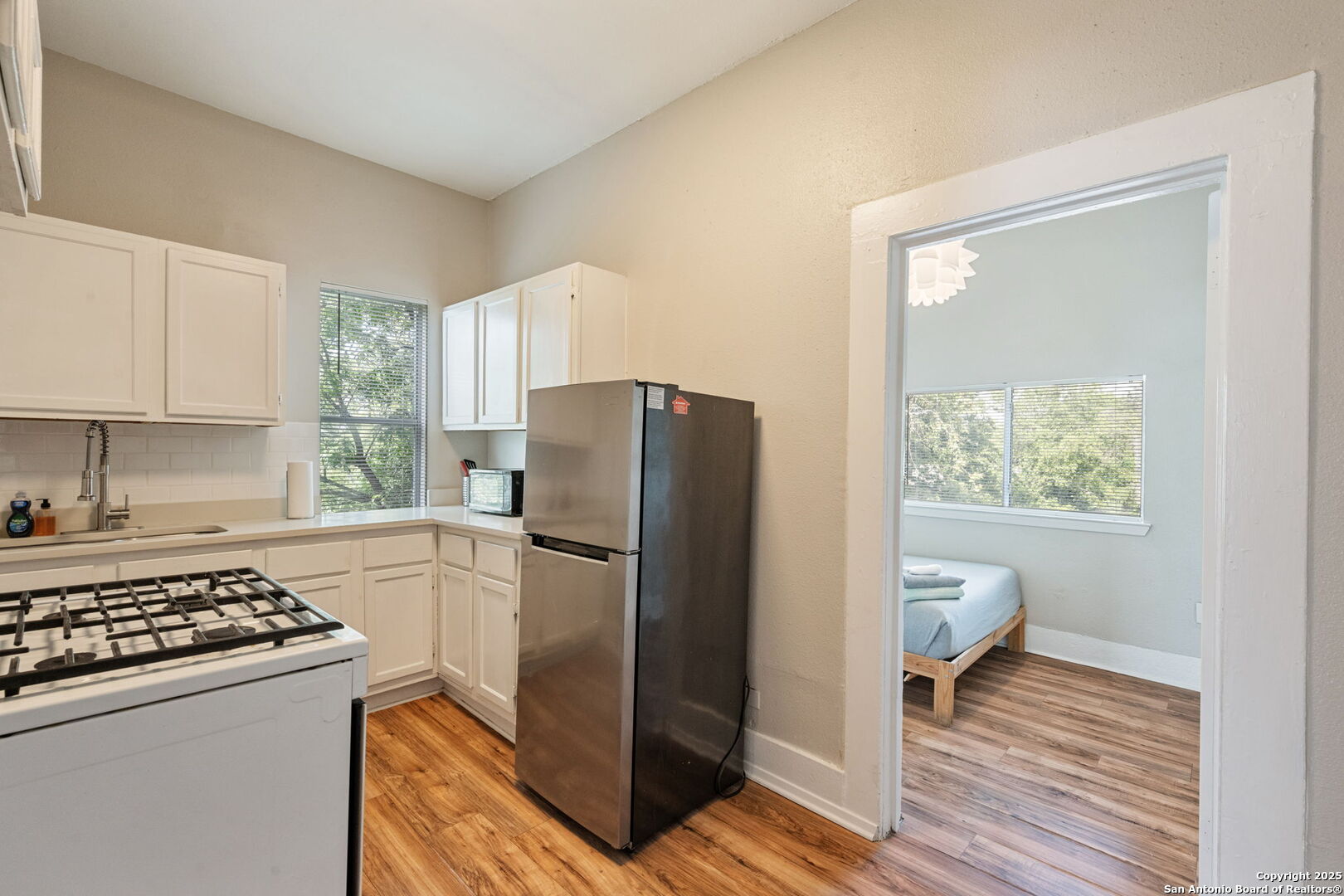 215 Blanco Road San Antonio, TX 78212 - Photo 33 of 48 a kitchen with a refrigerator and a stove top oven