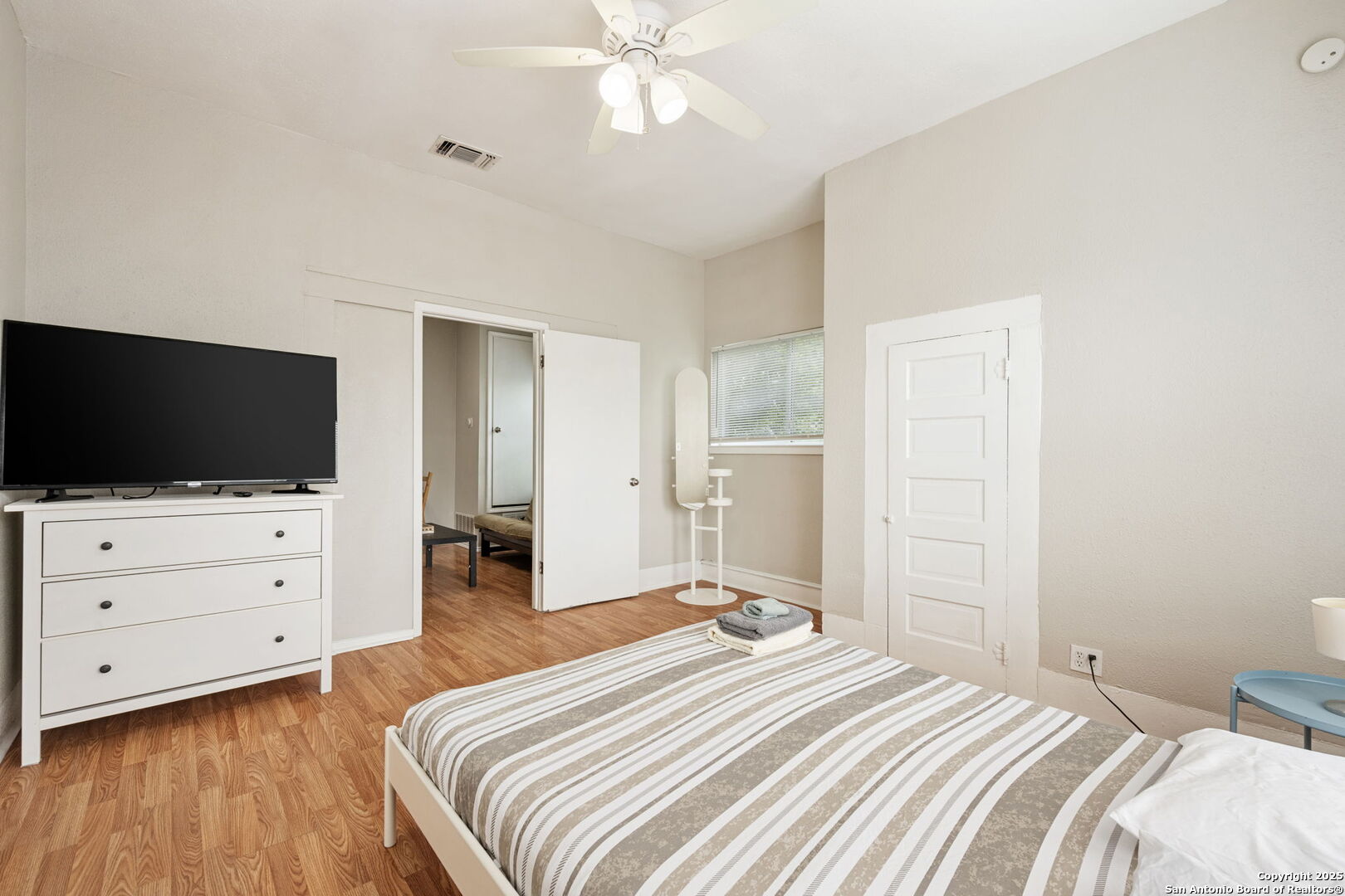215 Blanco Road San Antonio, TX 78212 - Photo 46 of 48 a bedroom with a bed and flat screen tv