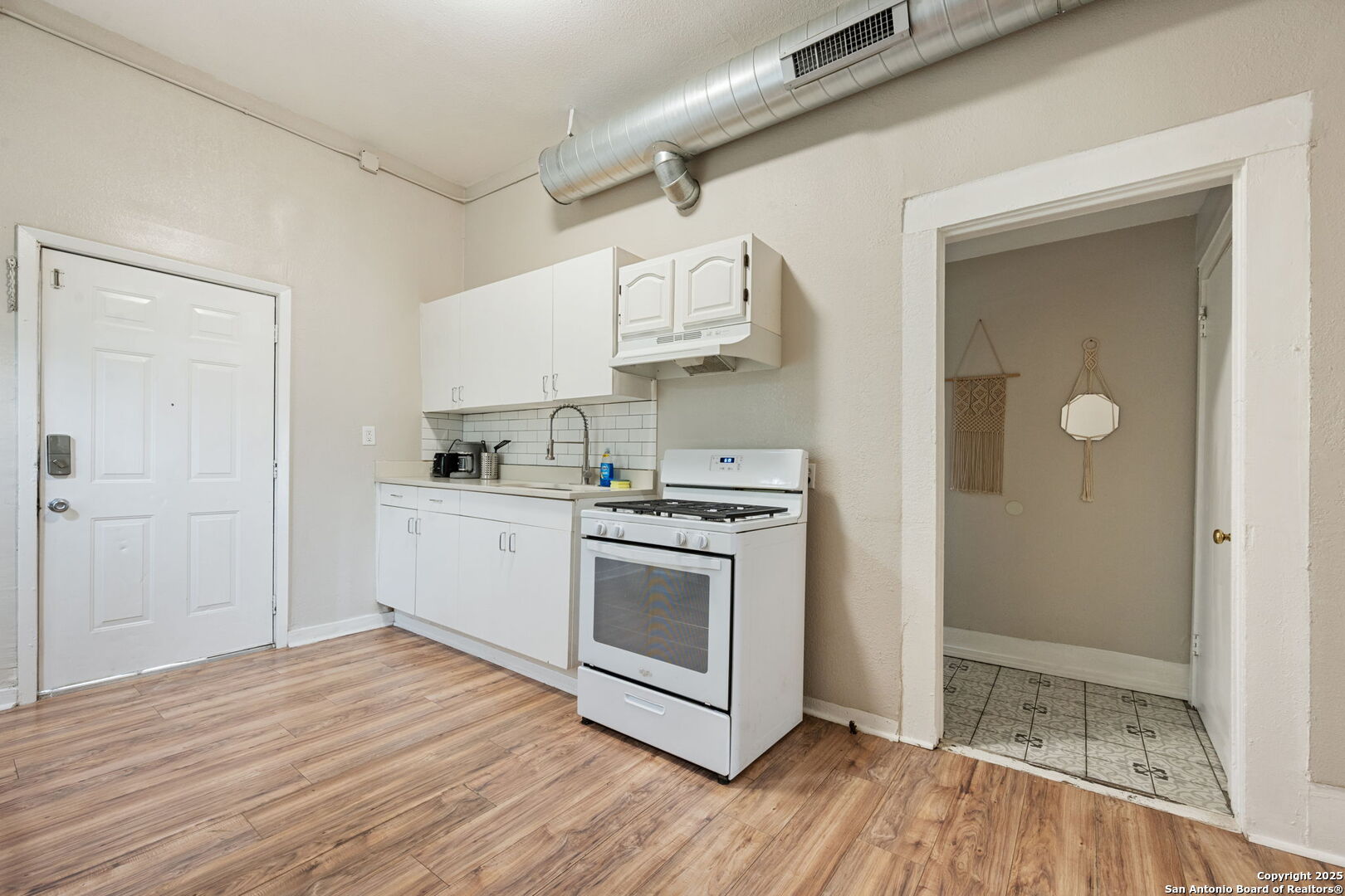 215 Blanco Road San Antonio, TX 78212 - Photo 10 of 48 a kitchen with stainless steel appliances granite countertop a sink and cabinets with wooden floor