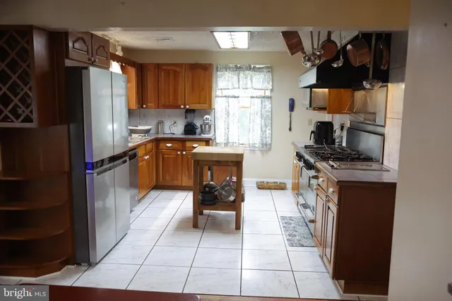 a stove top oven sitting inside of a kitchen